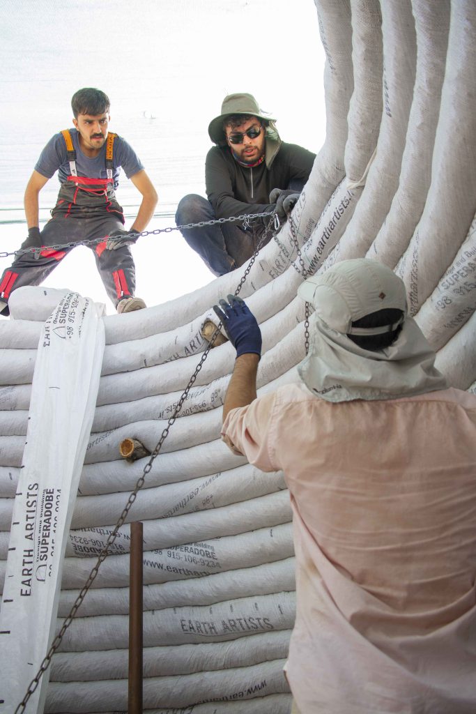Students are working together to build a superadobe