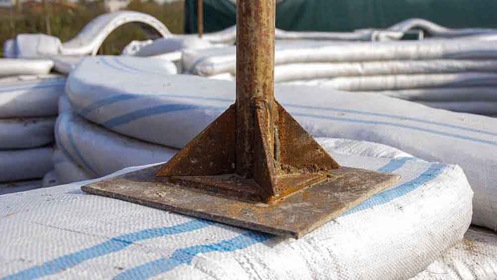 a tamper built to tamp superadobe filled sandbags